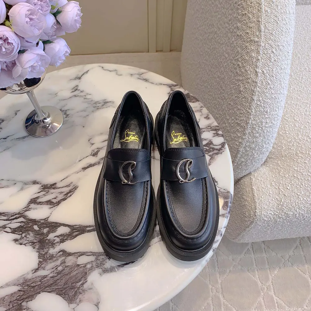 Close-up of signature red sole and silver hardware on Christian Louboutin loafers