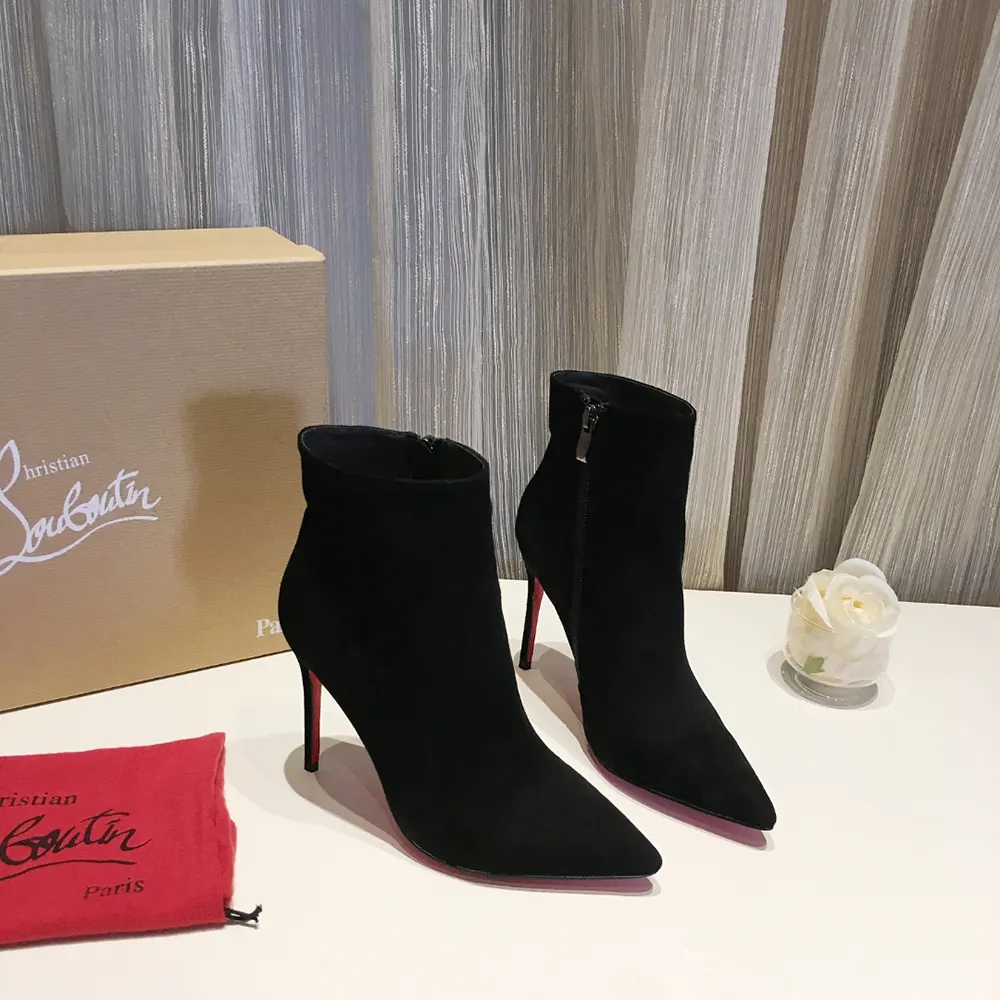 Close-up of red lacquered sole on Christian Louboutin So Apostropha Booty boots