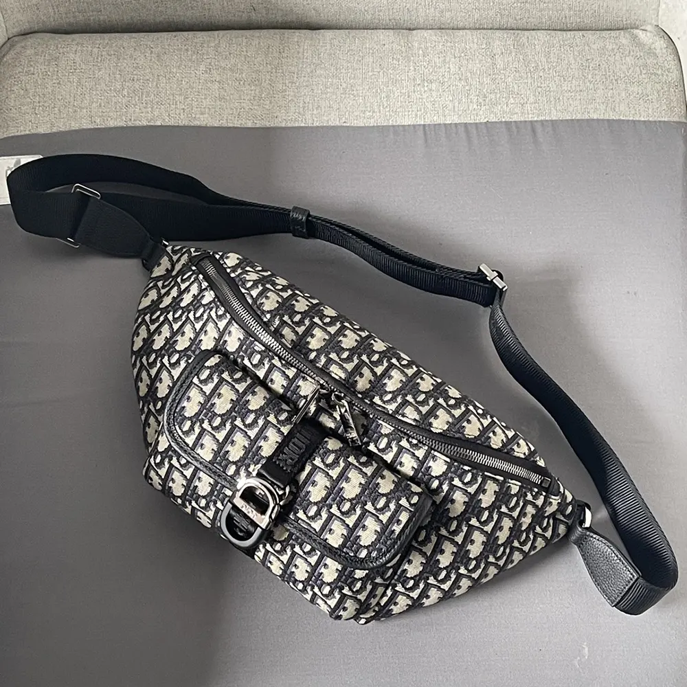 Close-up of black leather trim and silver-tone zipper on Dior Men Dior 8 Belt Bag
