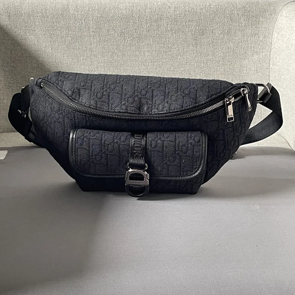 Close-up of silver-tone hardware on Dior Men Dior 8 Belt Bag