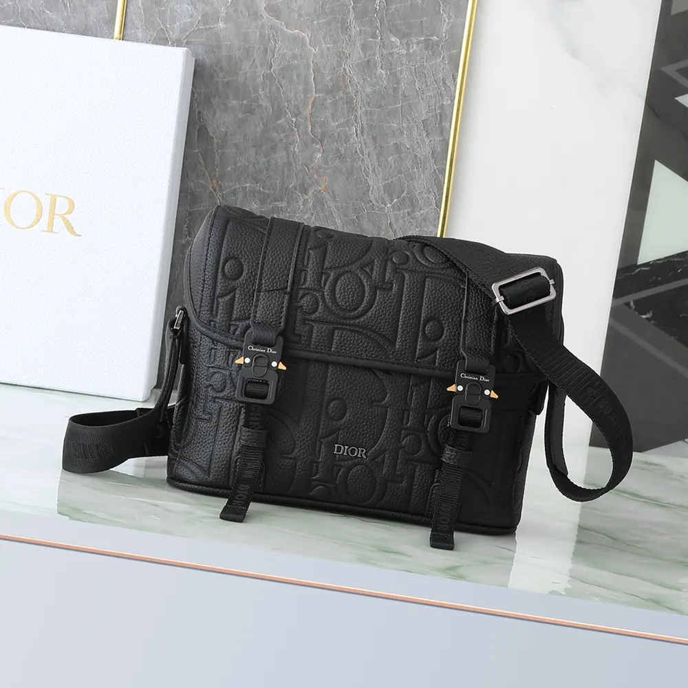 Close-up of black Dior Gravity leather texture on messenger bag