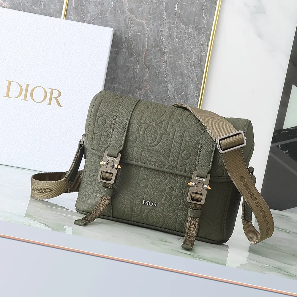 Close-up of Dior Gravity leather texture and silver hardware on the messenger bag