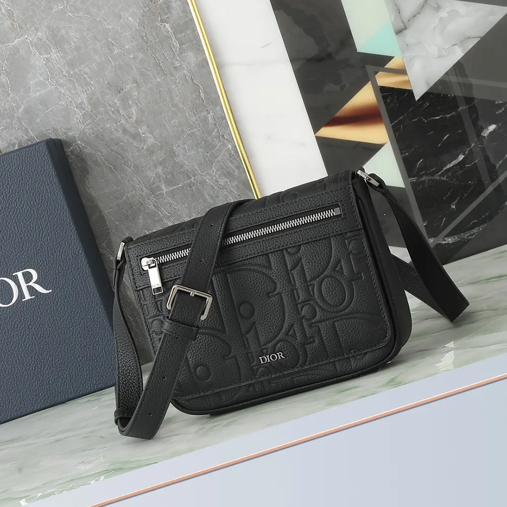 Close-up of flap closure and silver hardware on Dior Men Messenger Bag