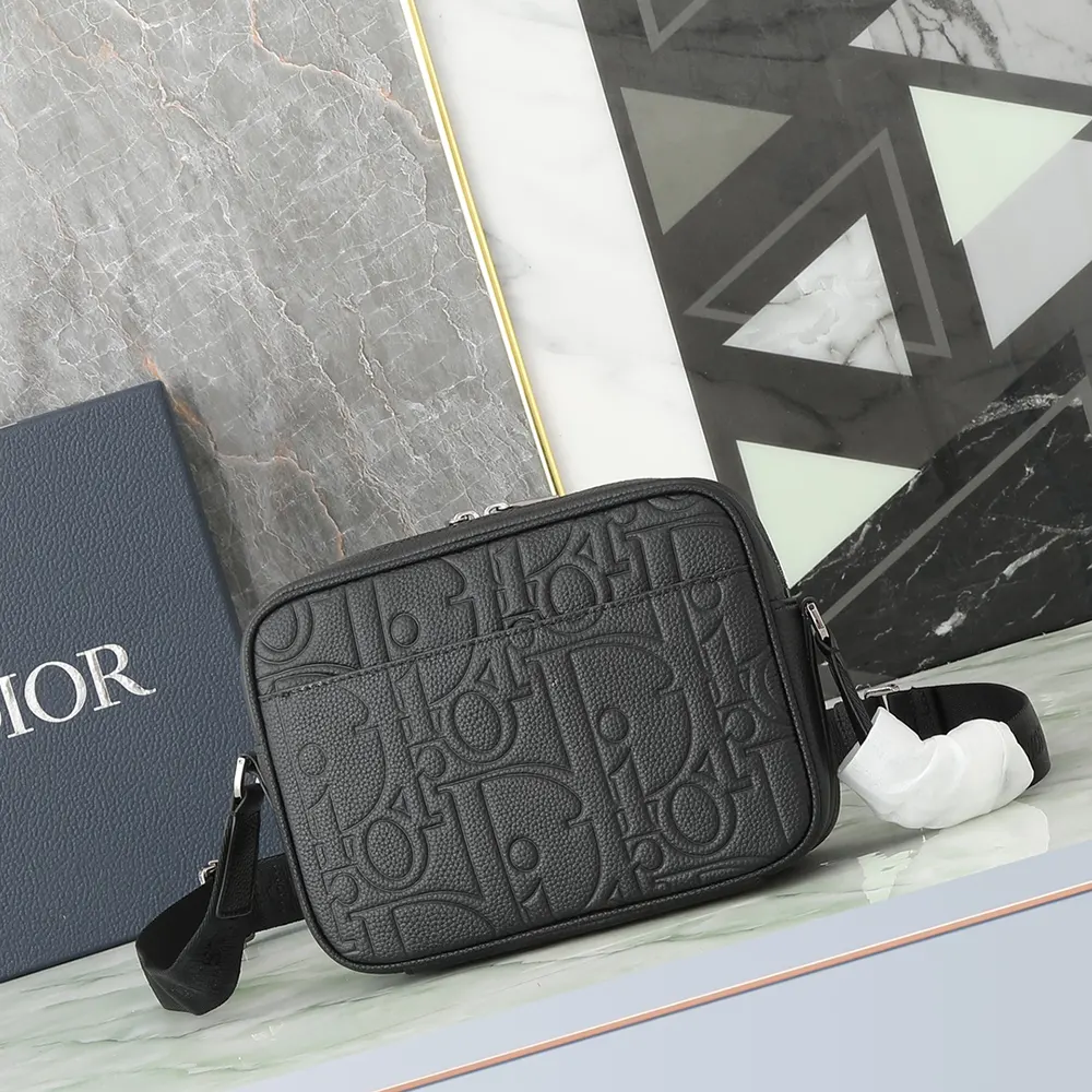 Side profile showing adjustable strap and matte hardware on Dior Men Rider 2.0 bag