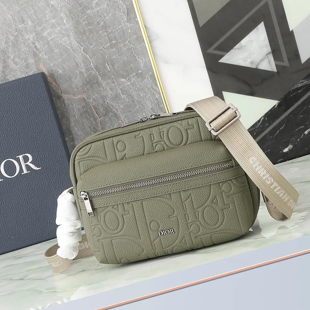 Close-up of zipped closure and gunmetal hardware on Dior Men Rider 2.0 bag