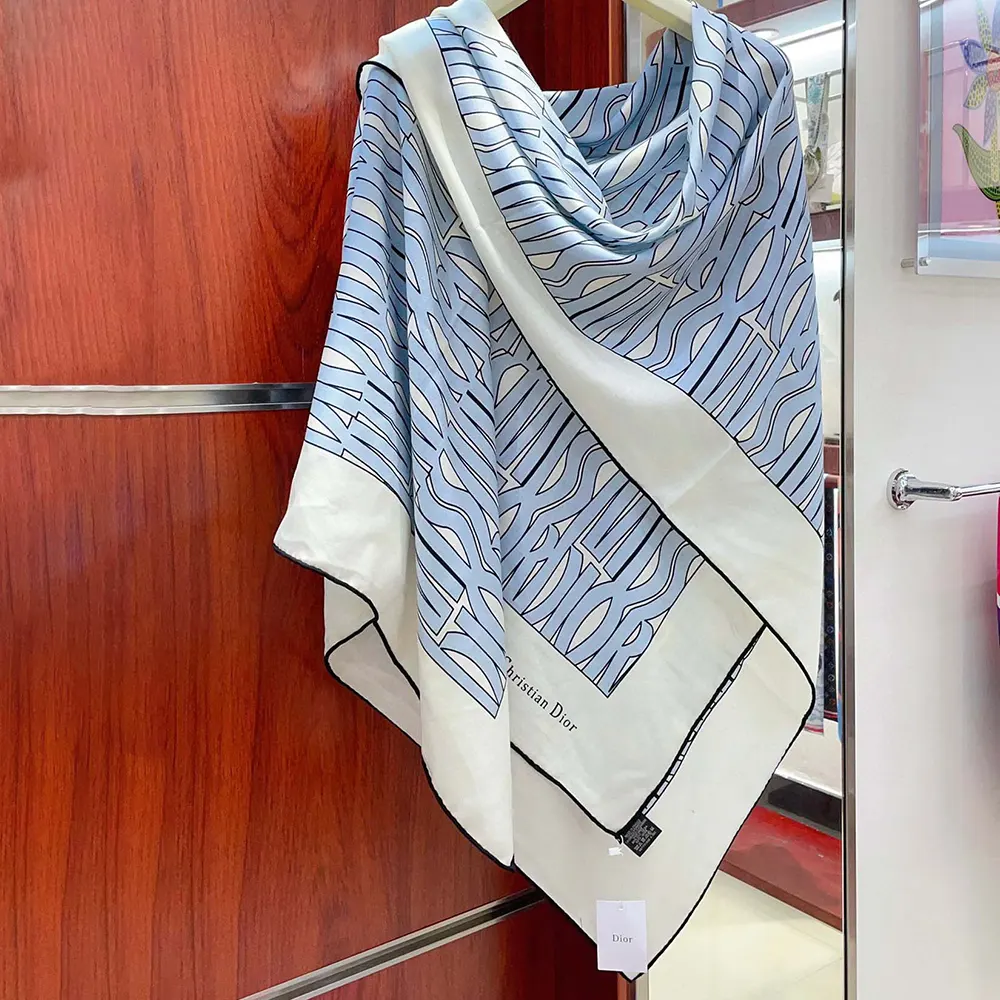 Close-up of the pale blue and white signature print on Dior scarf