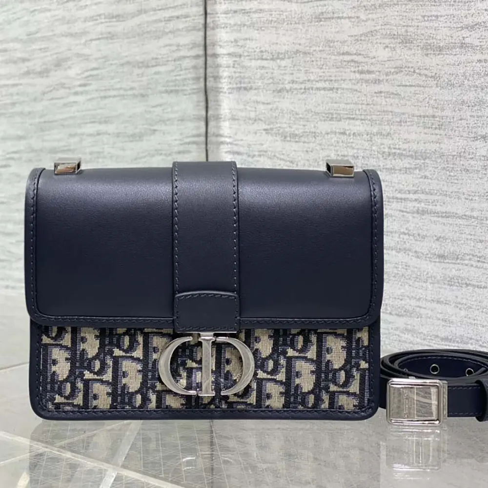 Close-up of silver ‘CD’ hardware on Dior Women 30 Montaigne Bag navy shoulder bag