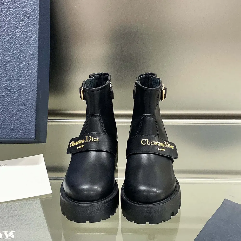 Close-up of Dior embossed hardware on black calfskin ankle boot zipper