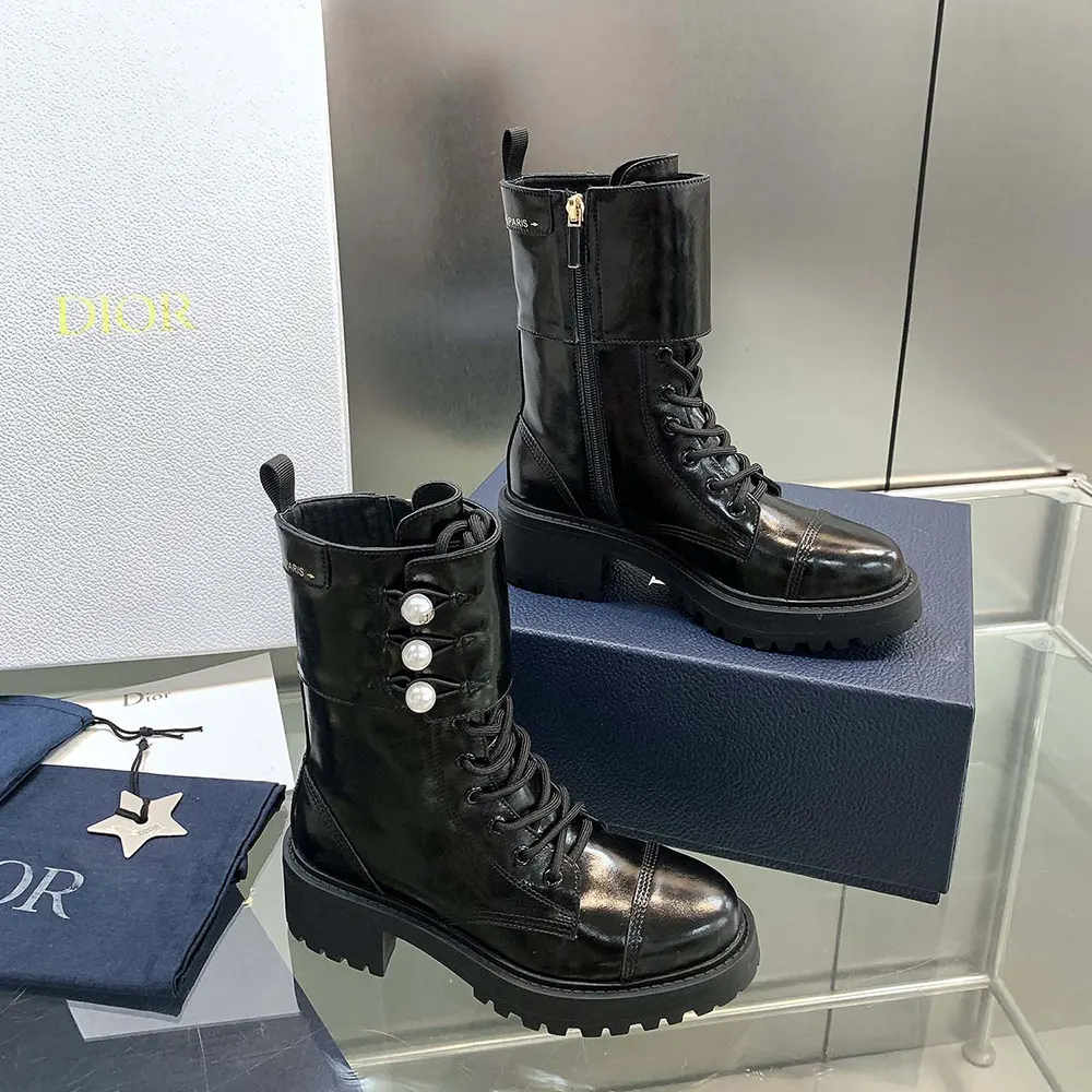Close-up of matte black calfskin and white resin pearls on Dior boot