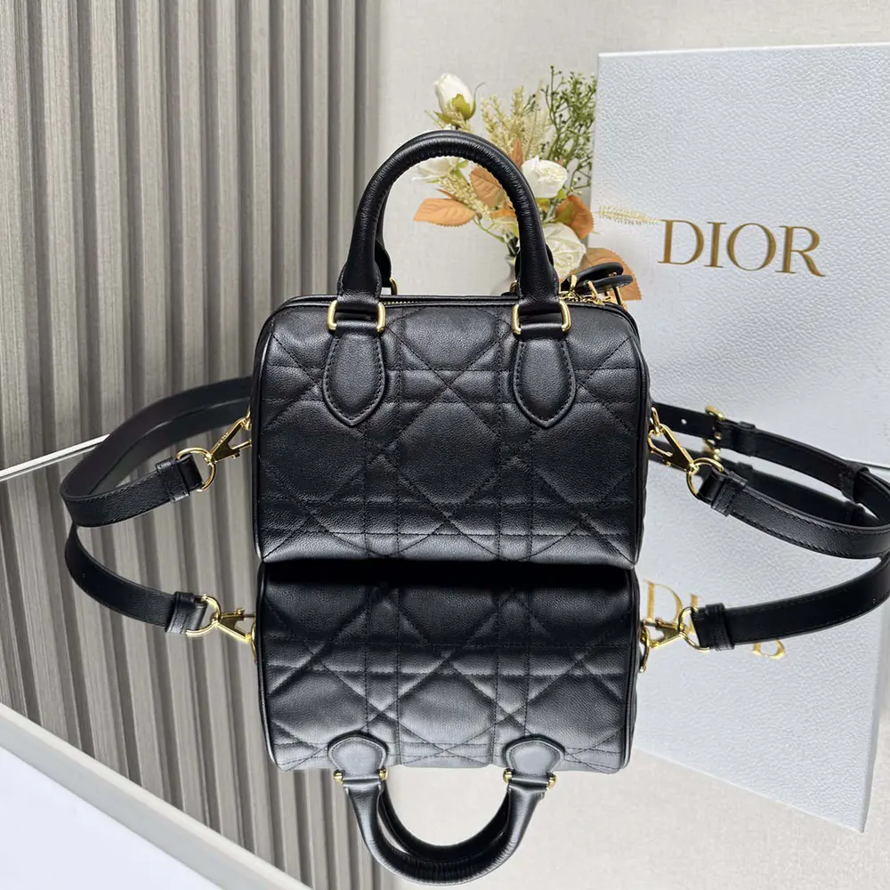 Side angle showing black metal ‘CD’ hardware on Dior Groove 20 bag