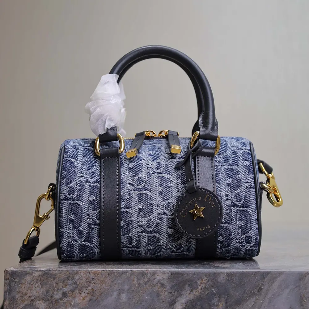 Close-up detail of blue denim texture on Dior Women Groove 20 Bag