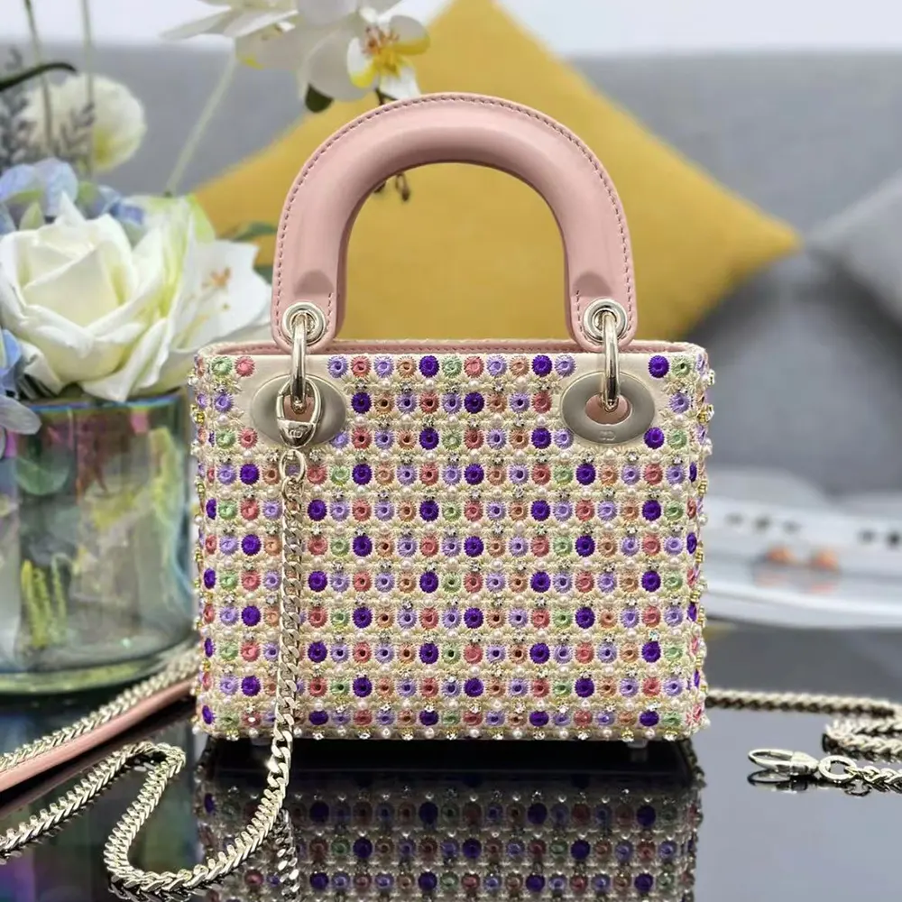Close-up on celestial pink bead embroidery and polished hardware on the Lady Dior Bag