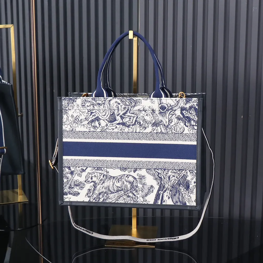 Side angle showing silver hardware on Dior Women Medium Dior Book Tote Navy Blue