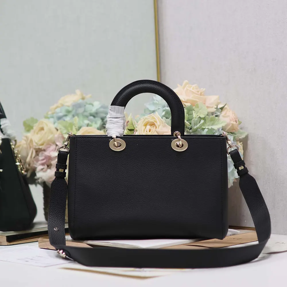 Close-up of silver-tone Dior hardware on black Taurillon leather bag