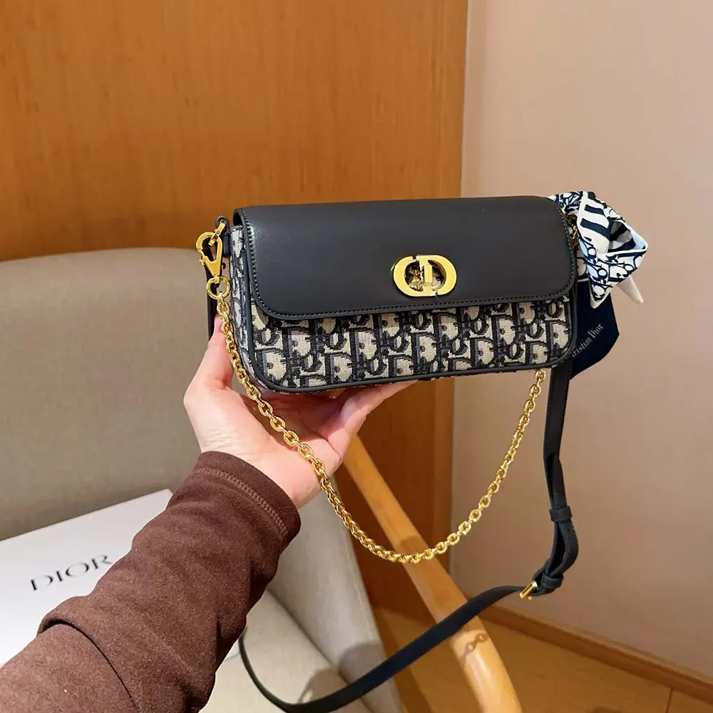 Side angle showing silver-tone chain strap of Dior Women Miss Caro Pouch