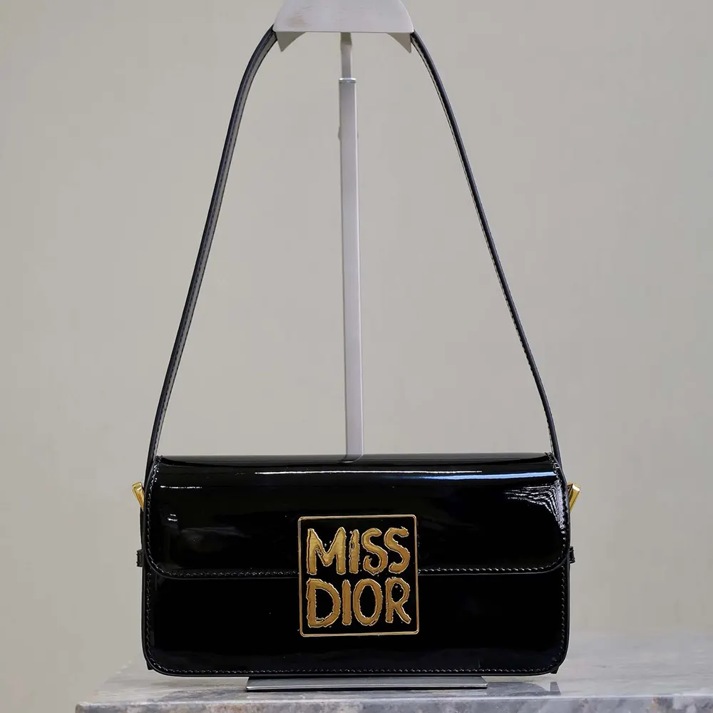 Close-up on polished silver hardware of Dior Women Miss Dior Flap Bag