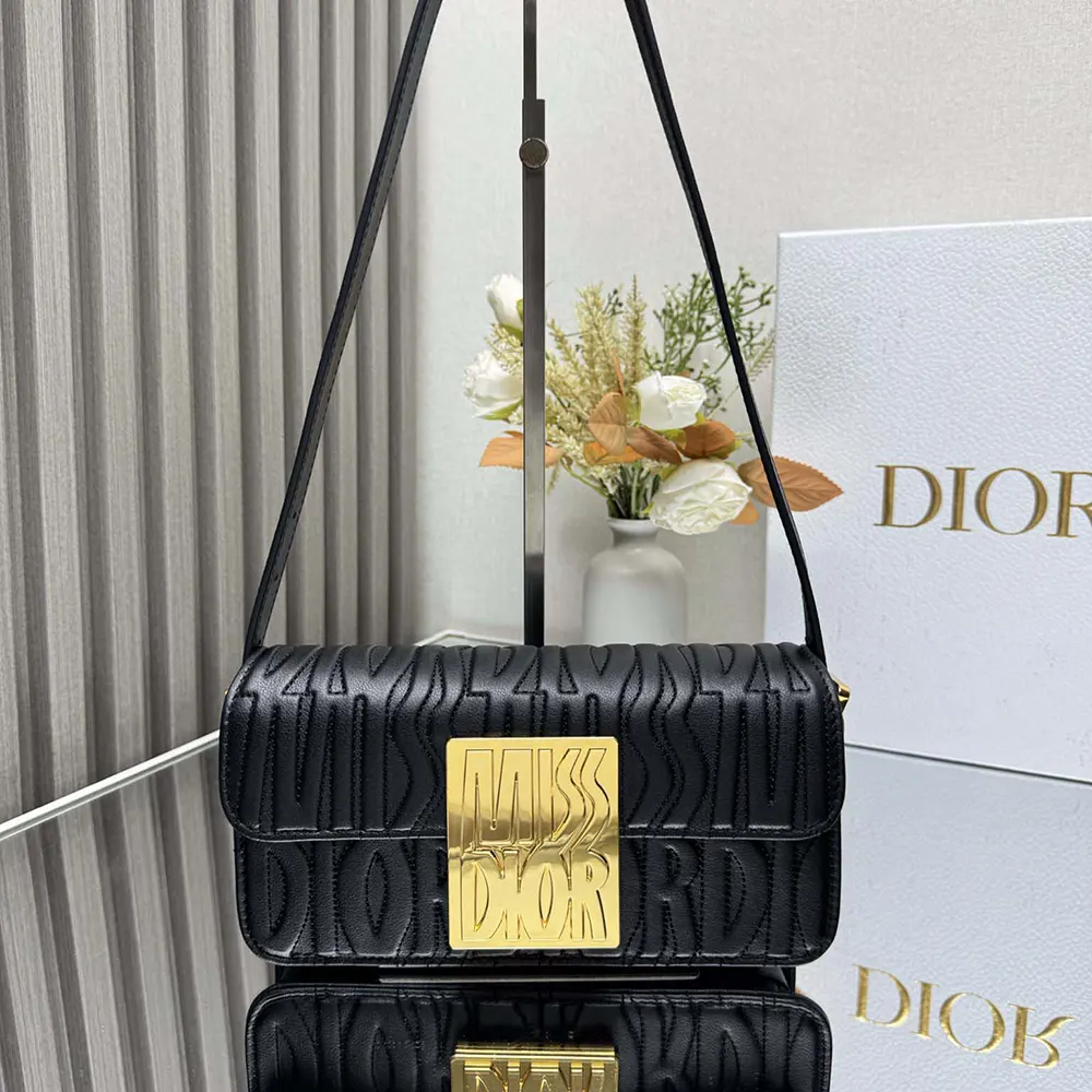 Close-up of silver-tone hardware and signature bow on Dior Women Miss Dior Flap Bag
