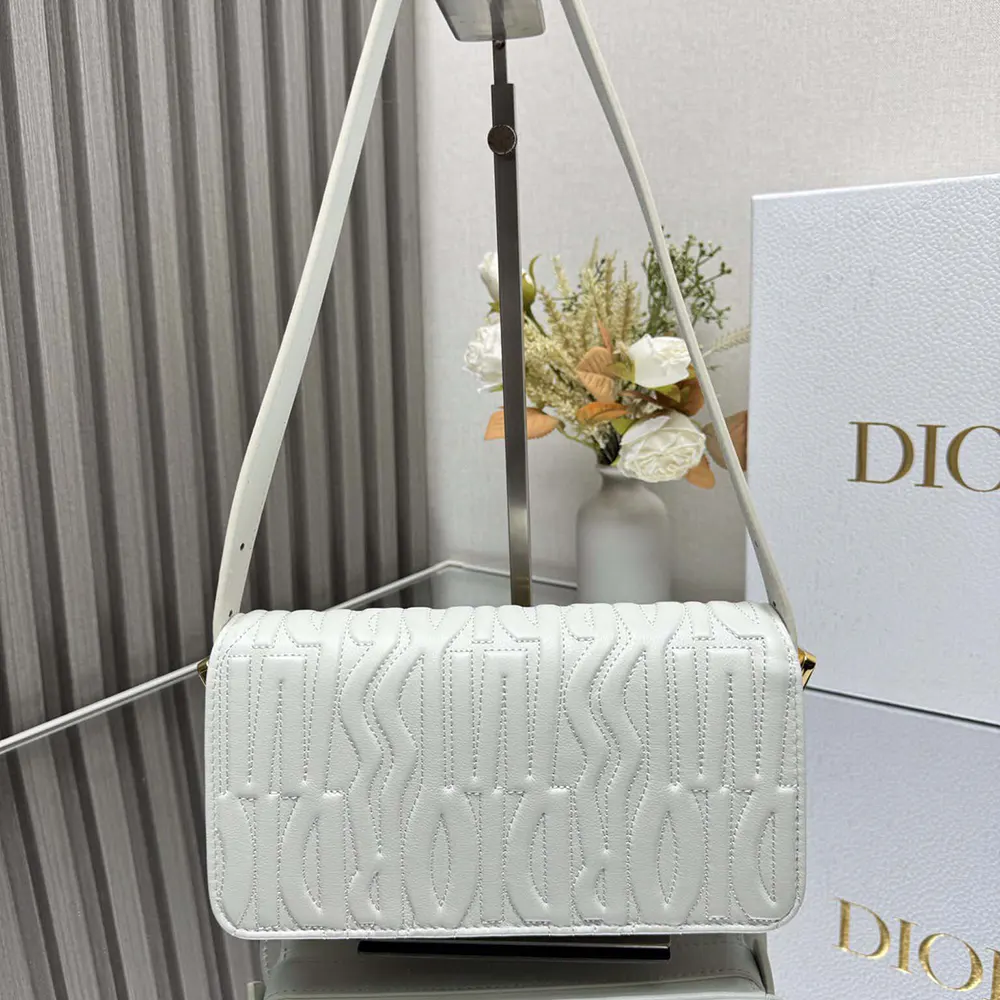 Side angle showing flap closure and adjustable strap on Dior Women Miss Dior Flap Bag
