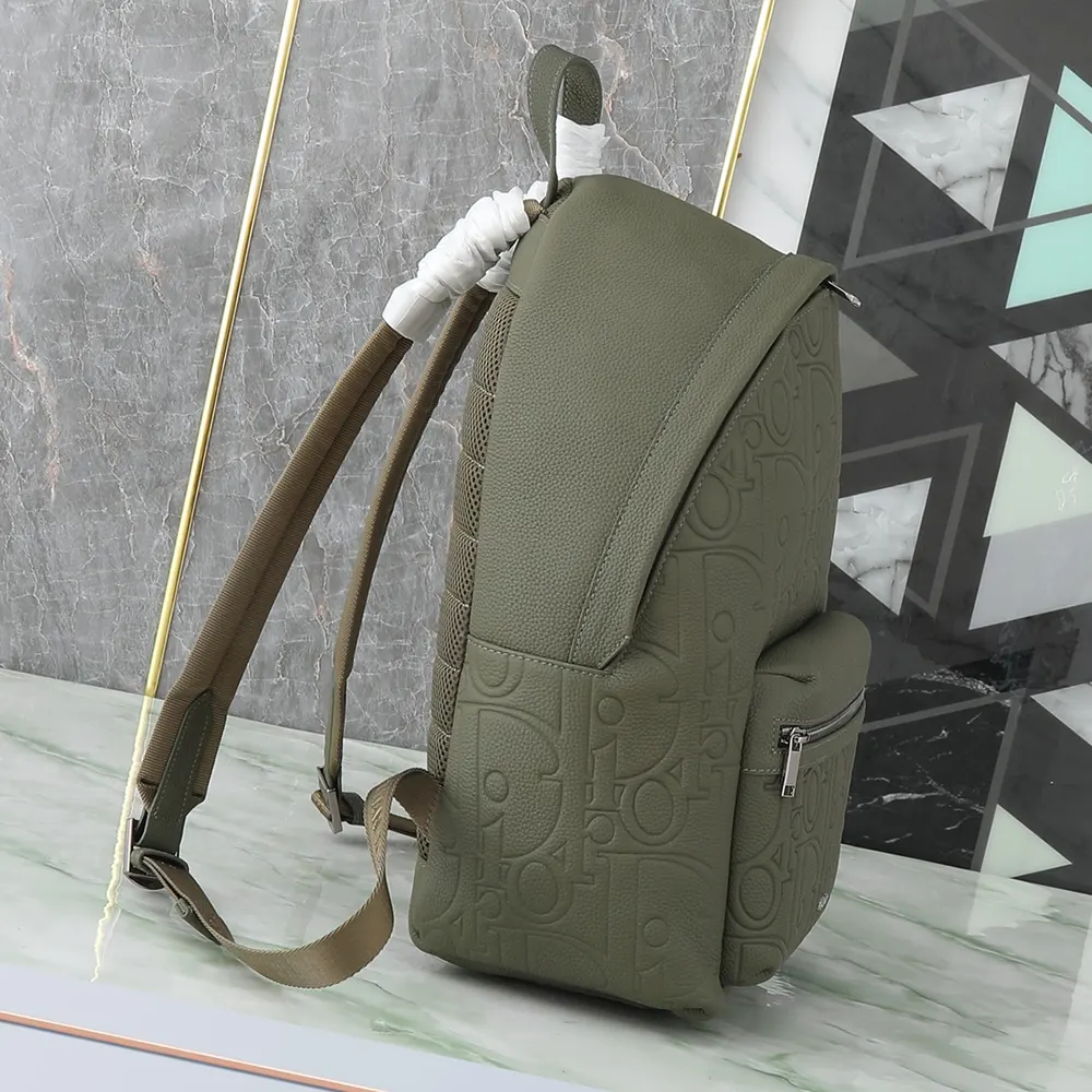 Side profile highlighting the textured calfskin of Dior Unisex Rider 2.0 Backpack Khaki