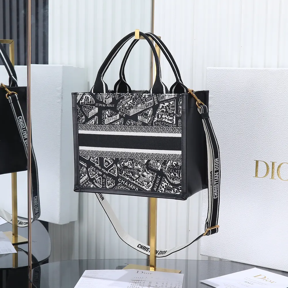 Side angle showing structured silhouette of Dior Women Small Dior Book Tote black and white