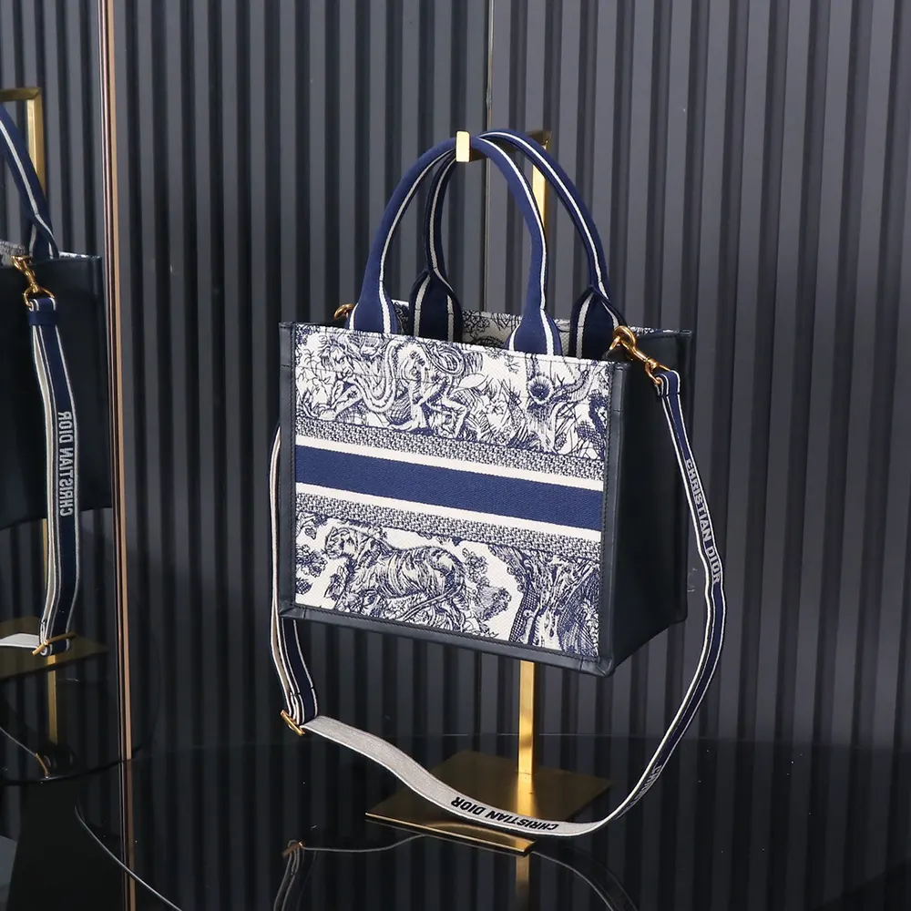Side angle showing silver hardware and structured silhouette of Dior Women Small Dior Book Tote
