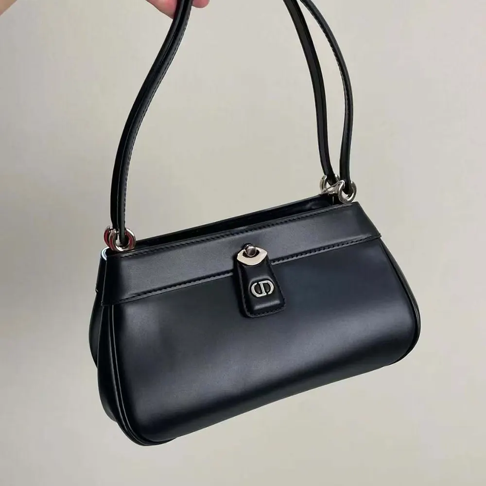 Side angle showing compact silhouette of Dior Small Dior Key Bag