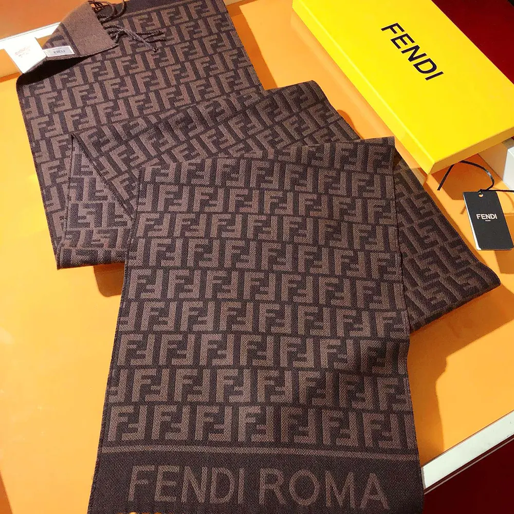 Close-up detail of Fendi FF logo on scarf fabric in burgundy