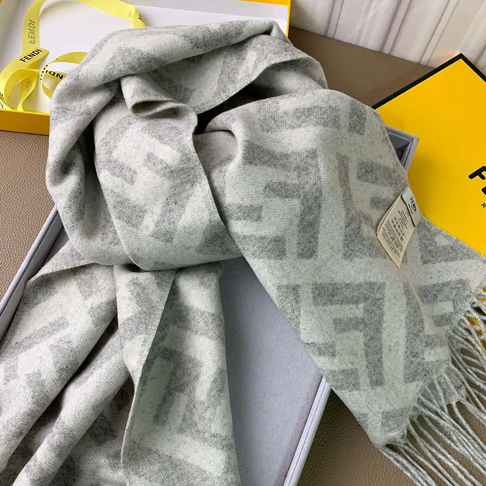 Close-up of Fendi FF logo detail on pale gray cashmere scarf