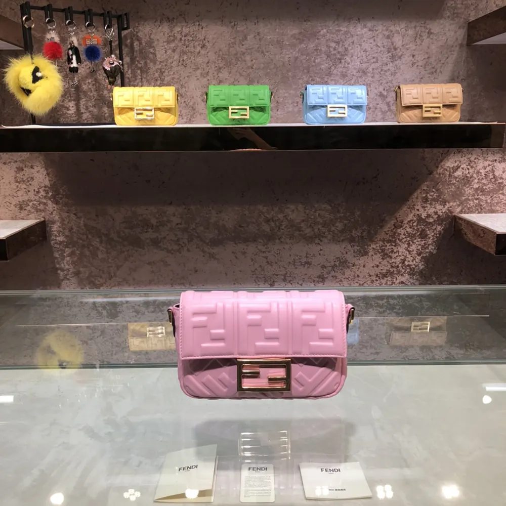 Close-up of gold-tone FF motif on Fendi Women Baguette Mini Pink Nappa Leather Bag
