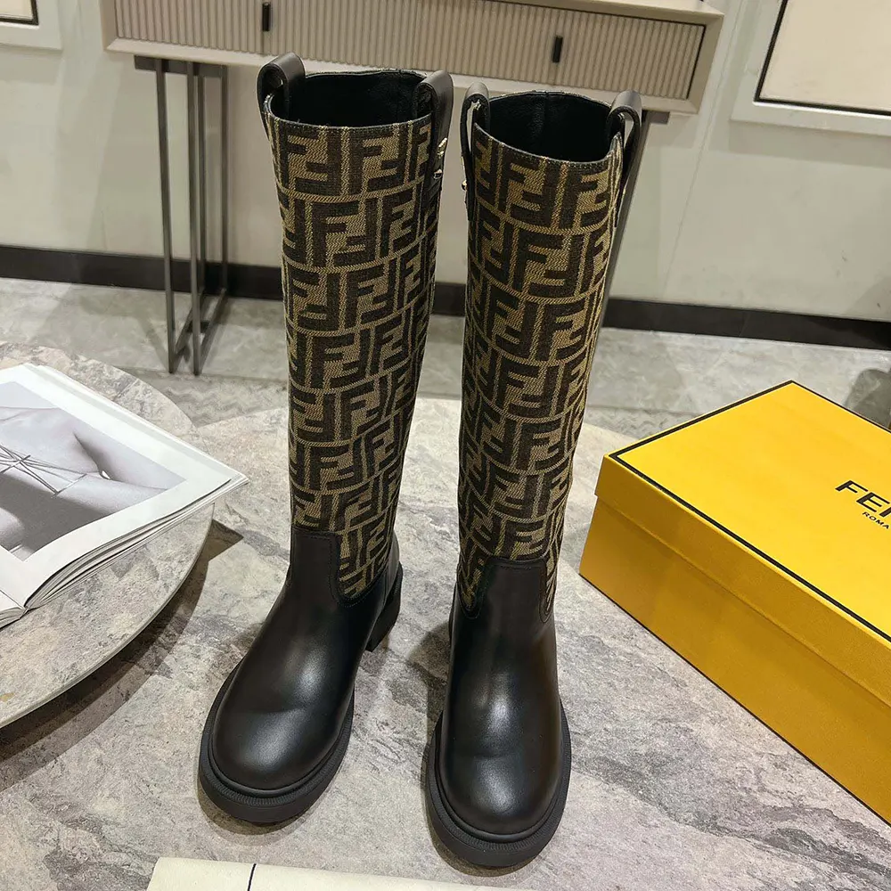 Close-up of gold hardware on Fendi Women Filo Black Leather and Brown FF Fabric Boots