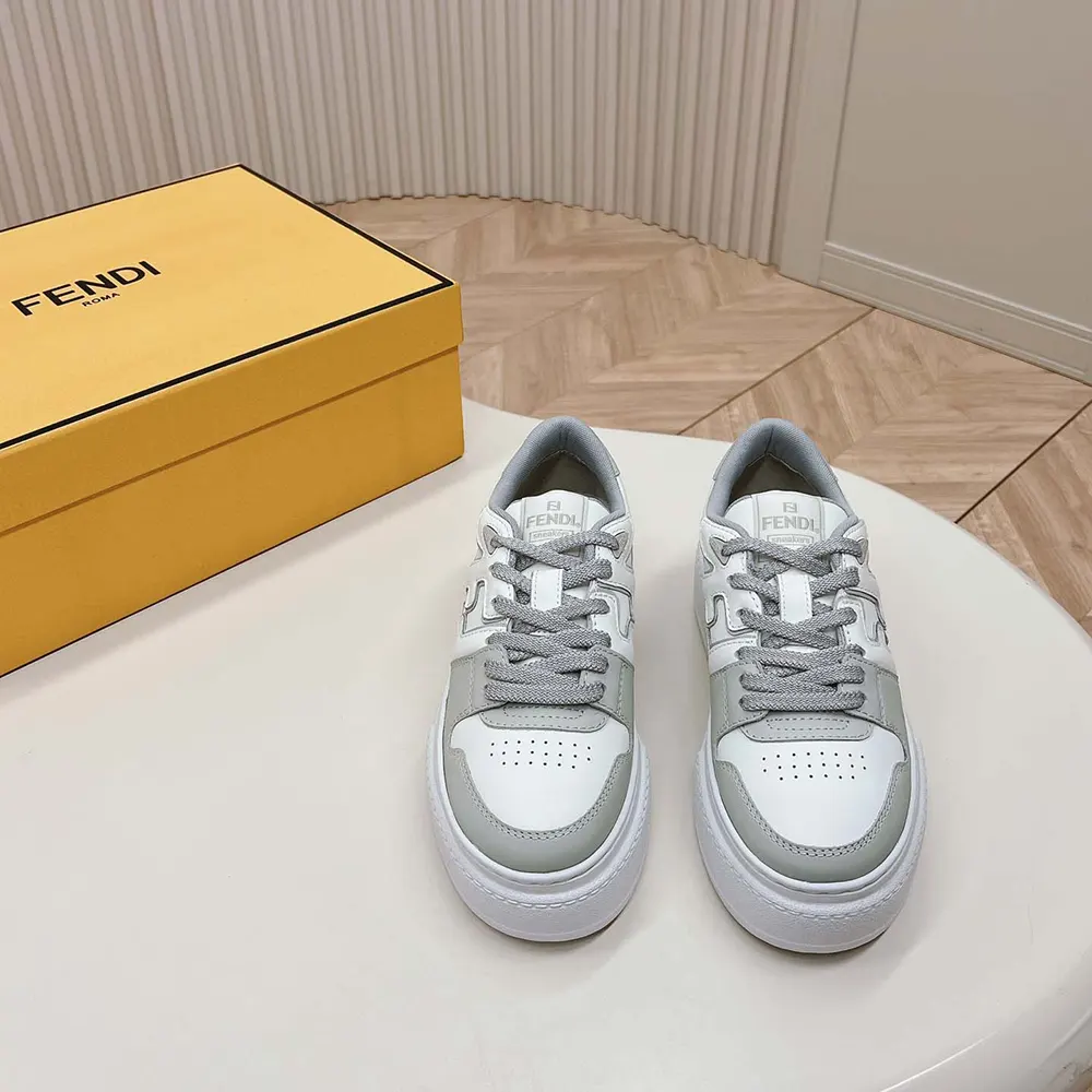 Close-up of Fendi branded hardware on gray leather platform low-tops