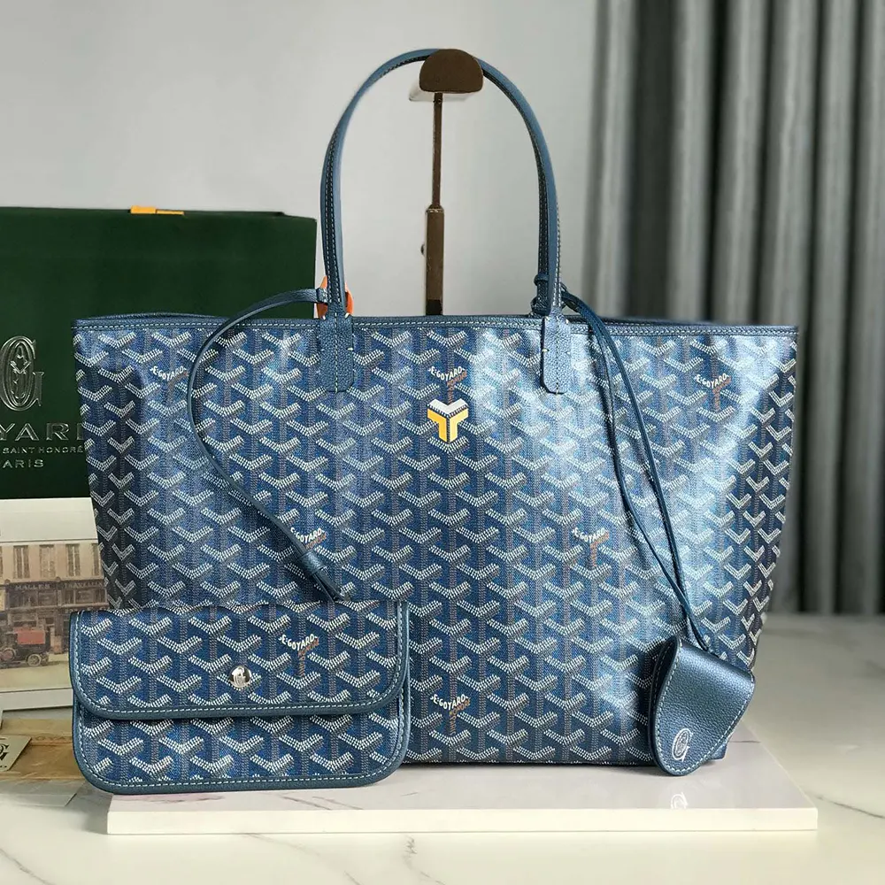 Close-up on pearly blue Goyardine canvas and gold hardware detail
