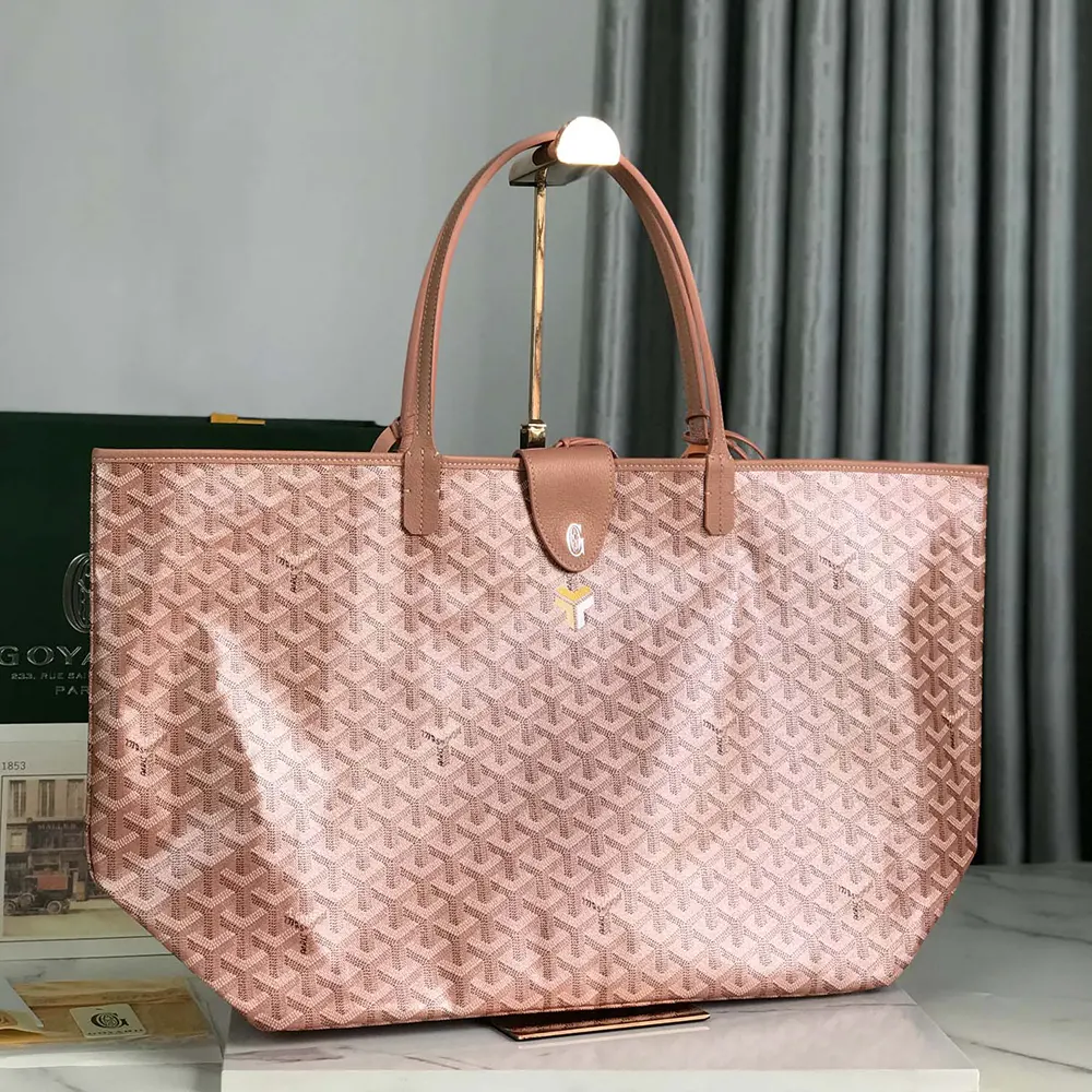 Side angle showing natural leather trim and brass rivets on bag