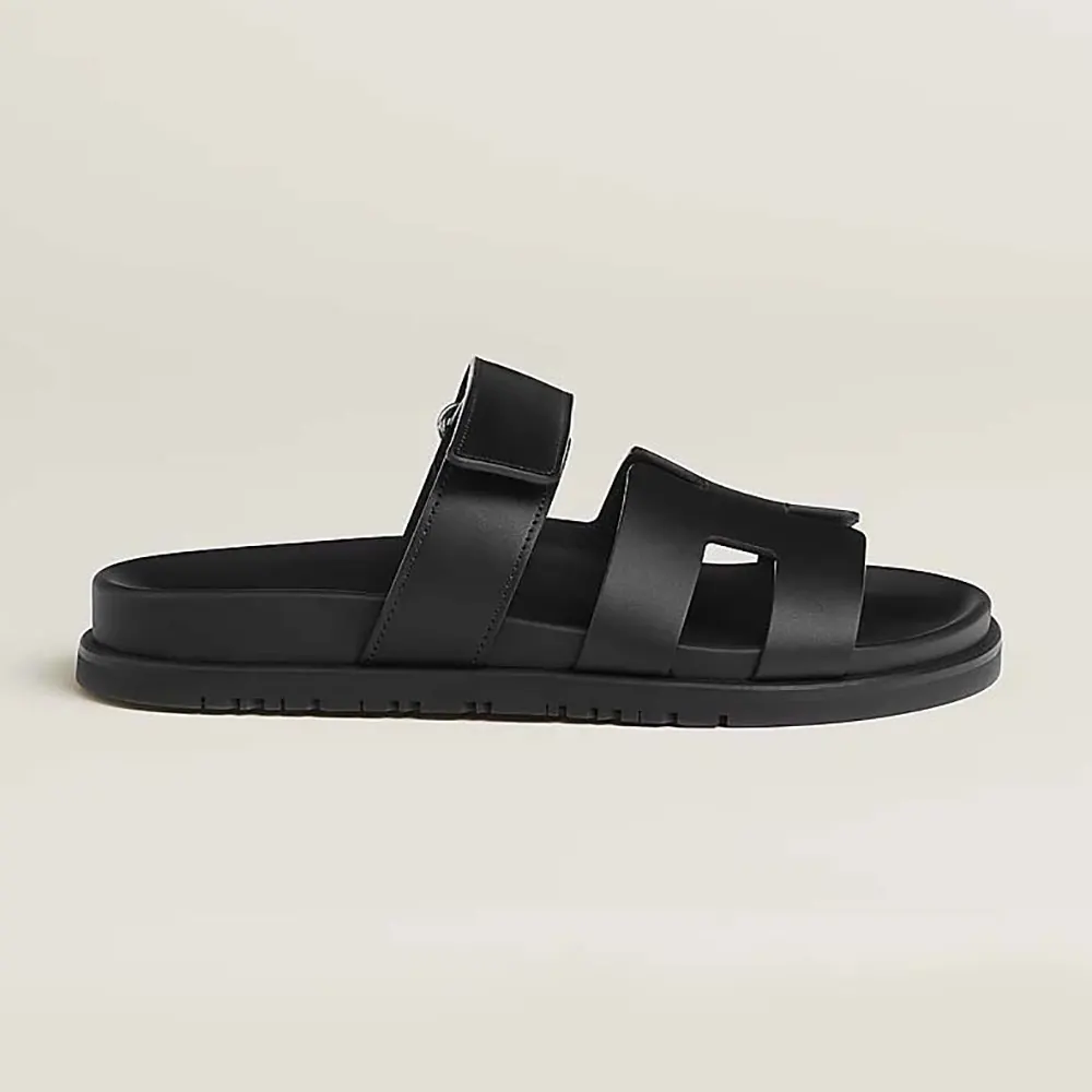 Side angle of Hermes Unisex Chypre Sandal-Black showing buckle detail