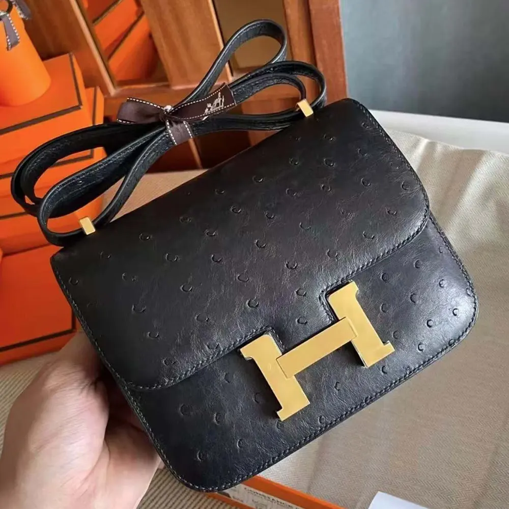 Side profile showing texture of Hermes Women Constance 19 Bag Nata Ostrich Leather-Black