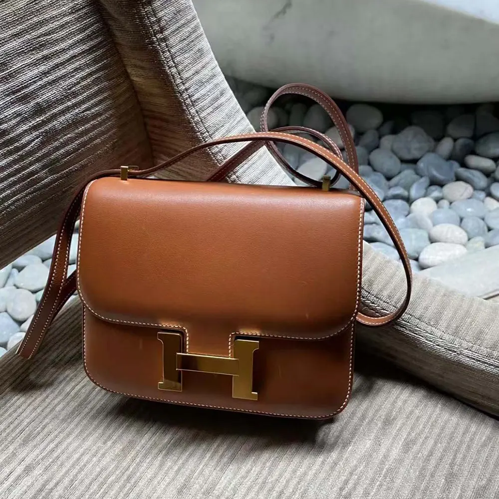 Close-up of gold Constance H hardware on Hermes Women Constance 24 Bag