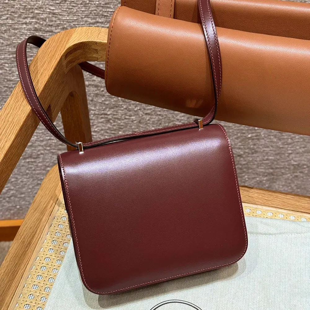 Side profile showing slim silhouette of Hermes Women Constance 24 Bag Maroon