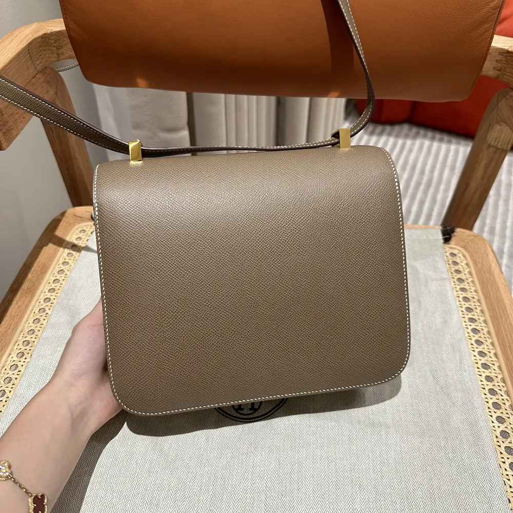 Side profile showing structured silhouette of Hermes Women Constance 24 Bag