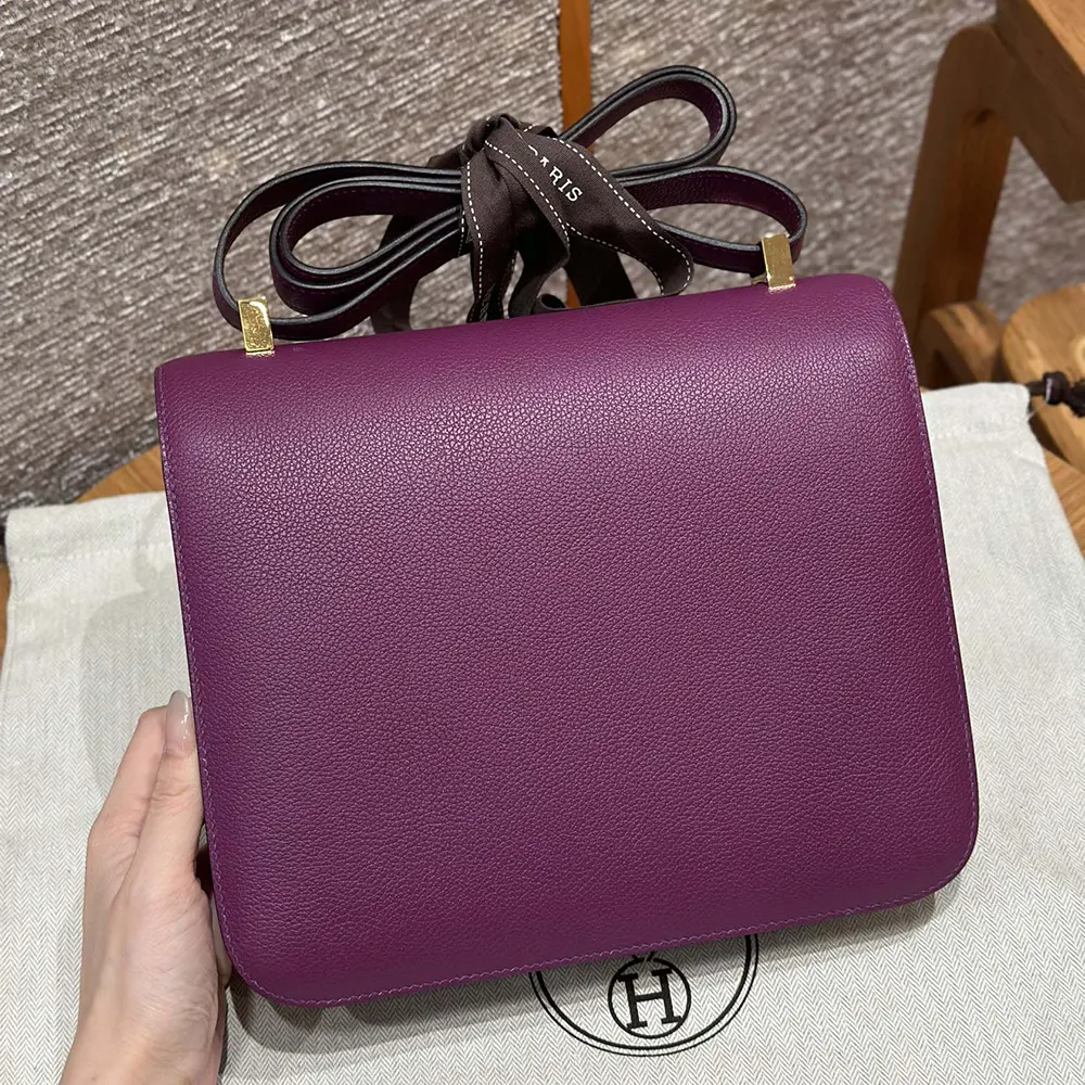 Side angle showing texture of purple Epsom leather Hermes Women Constance 24 Bag