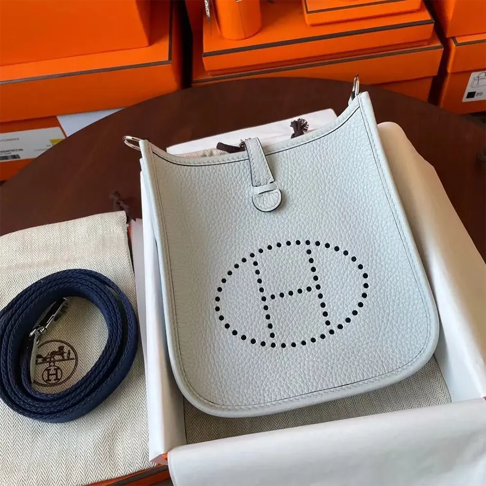 Close-up on silver hardware and signature perforated 'H' closure detail