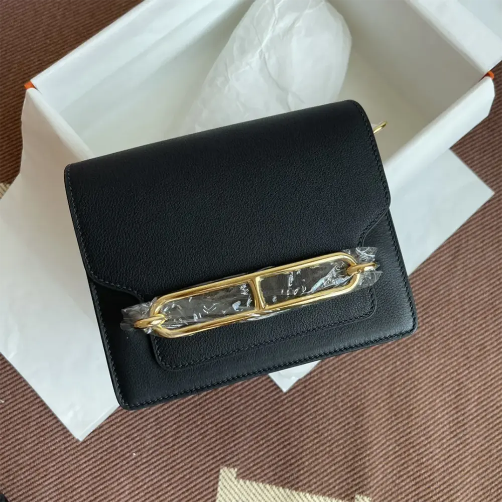 Close-up of gold clasp on Hermes Women Roulis Mini Bag
