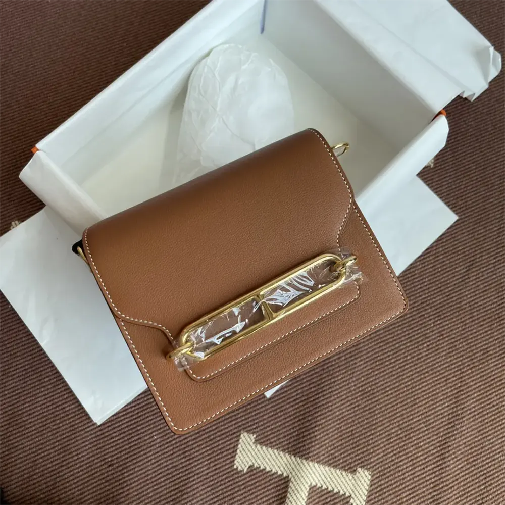 Close-up of gold clasp detail on Hermes Women Roulis Mini Bag