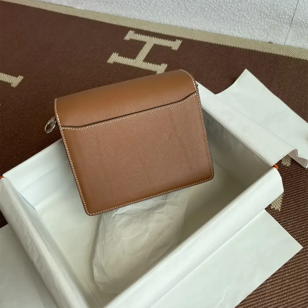 Side angle showing slim silhouette of Hermes Women Roulis Mini Bag