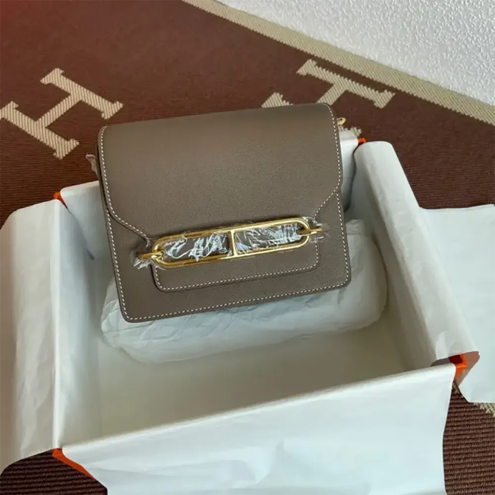 Close-up of gold clasp detail on Hermes Women Roulis Mini Bag