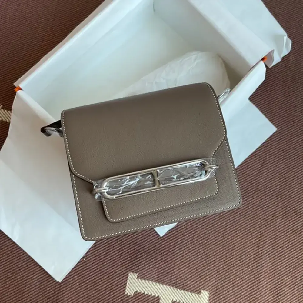 Close-up of silver ‘H’ clasp on Hermes Women Roulis Mini Bag