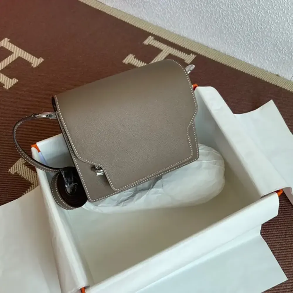 Side angle showing the compact silhouette of Hermes Women Roulis Mini Bag