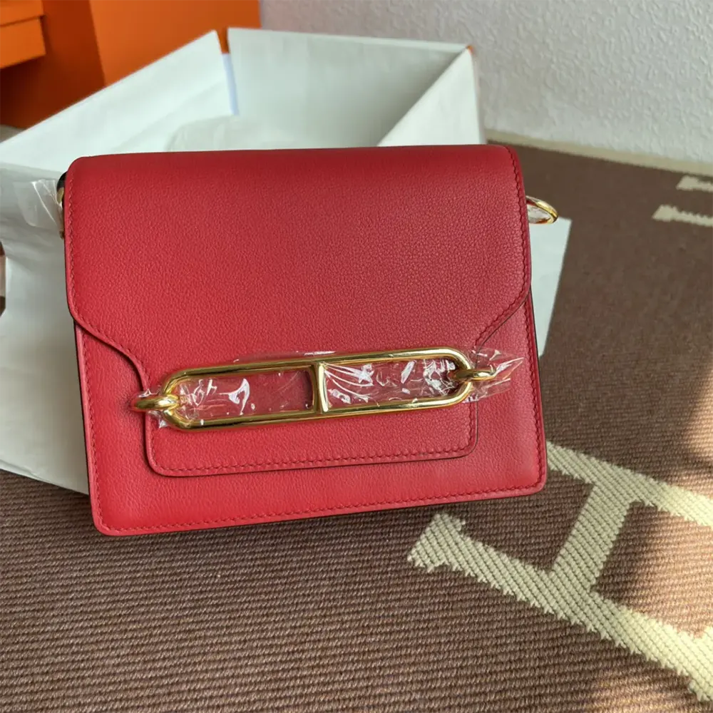 Front view of Hermes Women Roulis Mini Bag in red leather with gold hardware