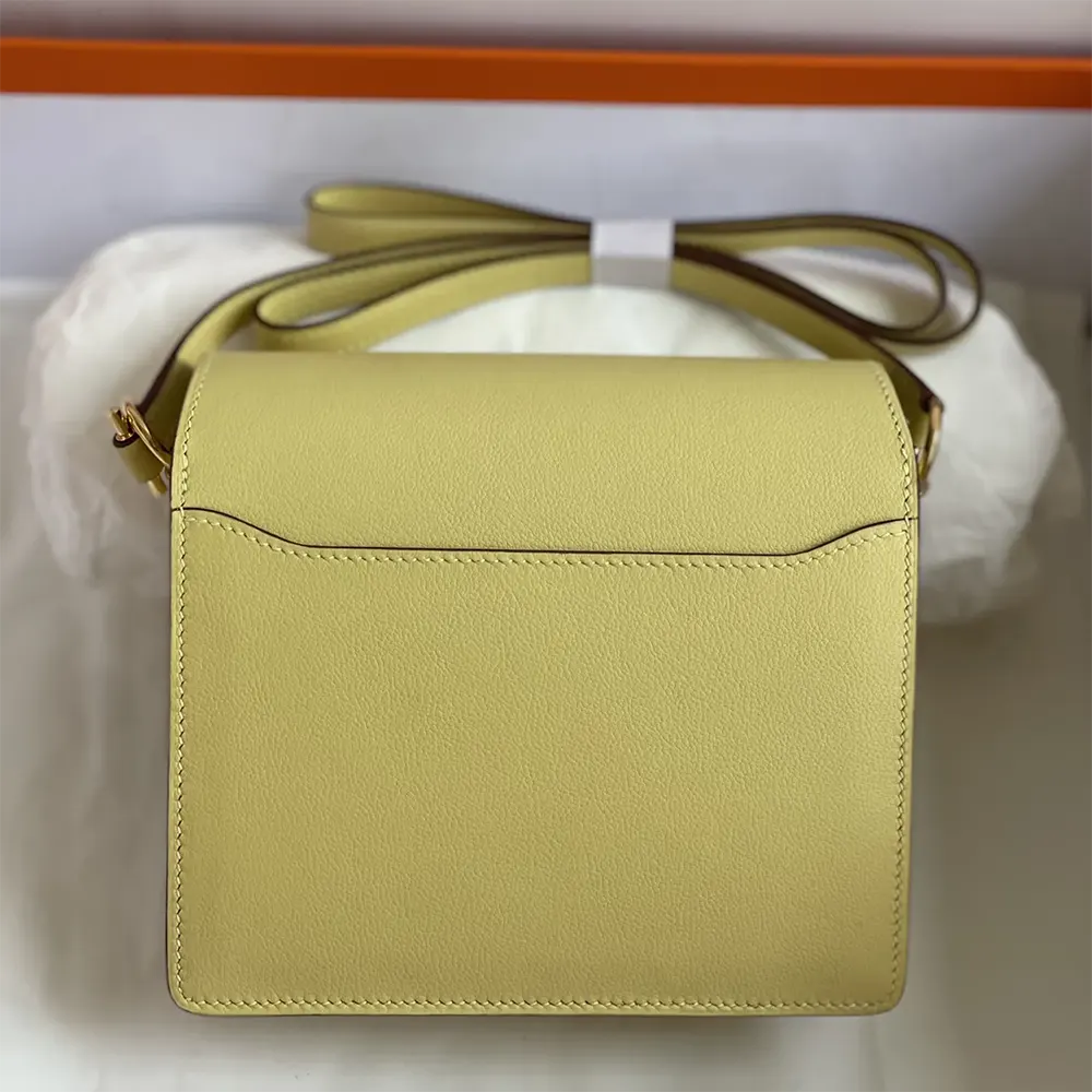 Side angle showing Hermes Women Roulis Mini Bag yellow shoulder strap