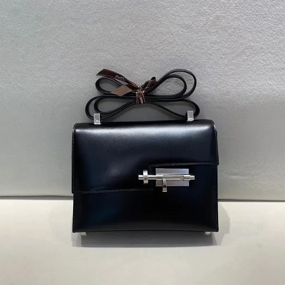Close-up on polished silver Verrou clasp of Hermes Women Verrou Bag