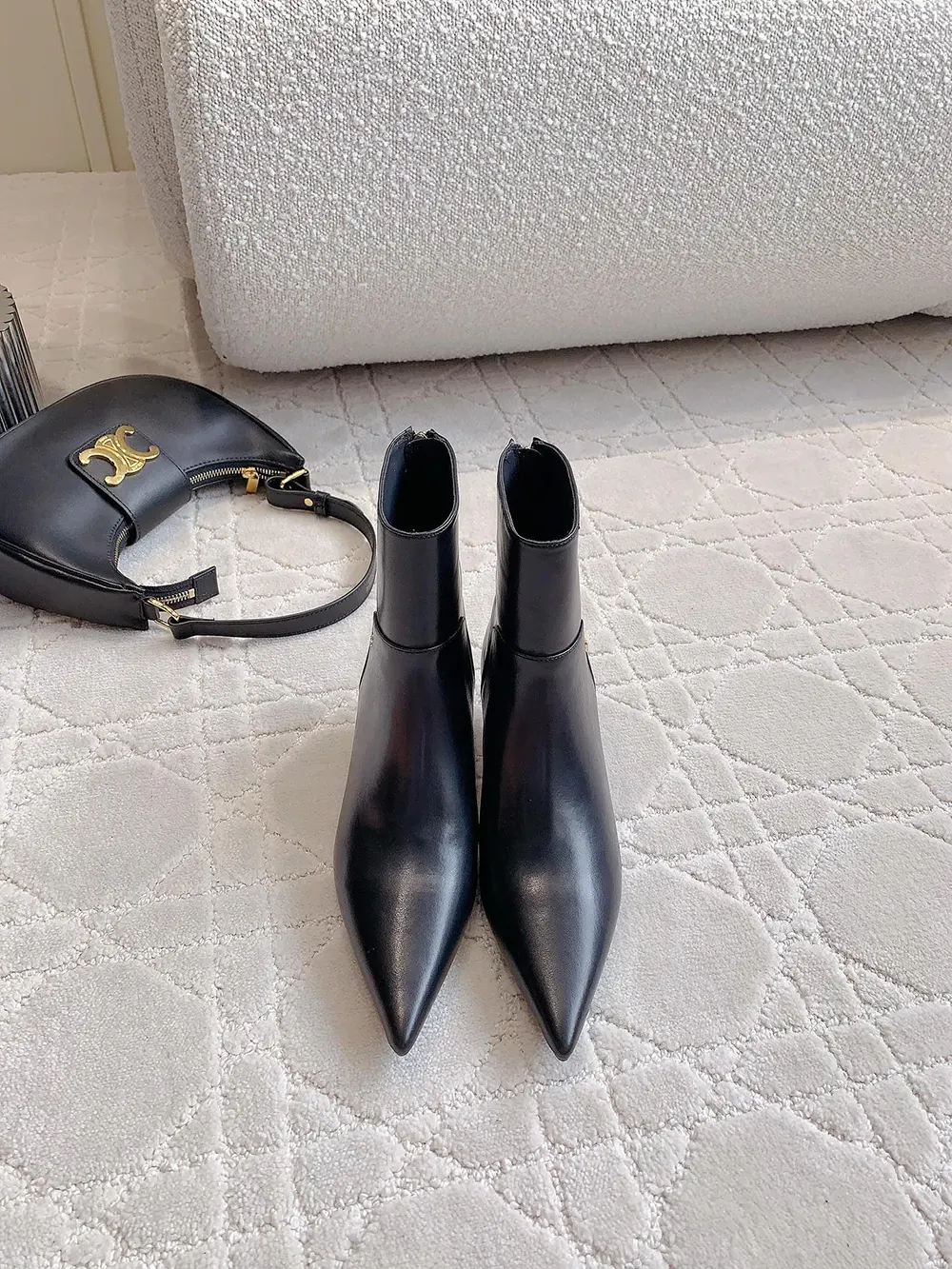 Close-up of black nappa leather and silver hardware on Jimmy Choo ankle boots